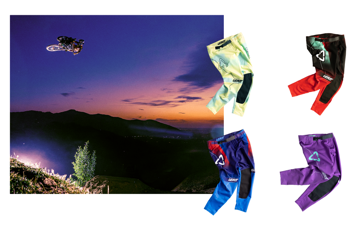 Four pairs of motocross pants in different colors (yellow-green, black/red, blue/red, and purple) are displayed on a white background next to a scenic mountain landscape photo at sunset. The pants feature knee pads and a visible Leatt logo.